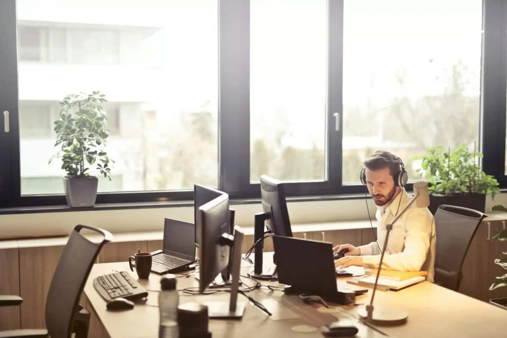 An agent manages his call center operations on his computer.