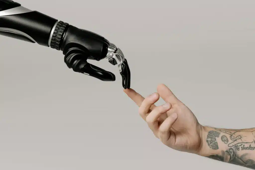 A bionic, artificial intelligence-driven hand touches fingers with a human hand